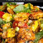 Shrimp and corn salad in a dark bowl.