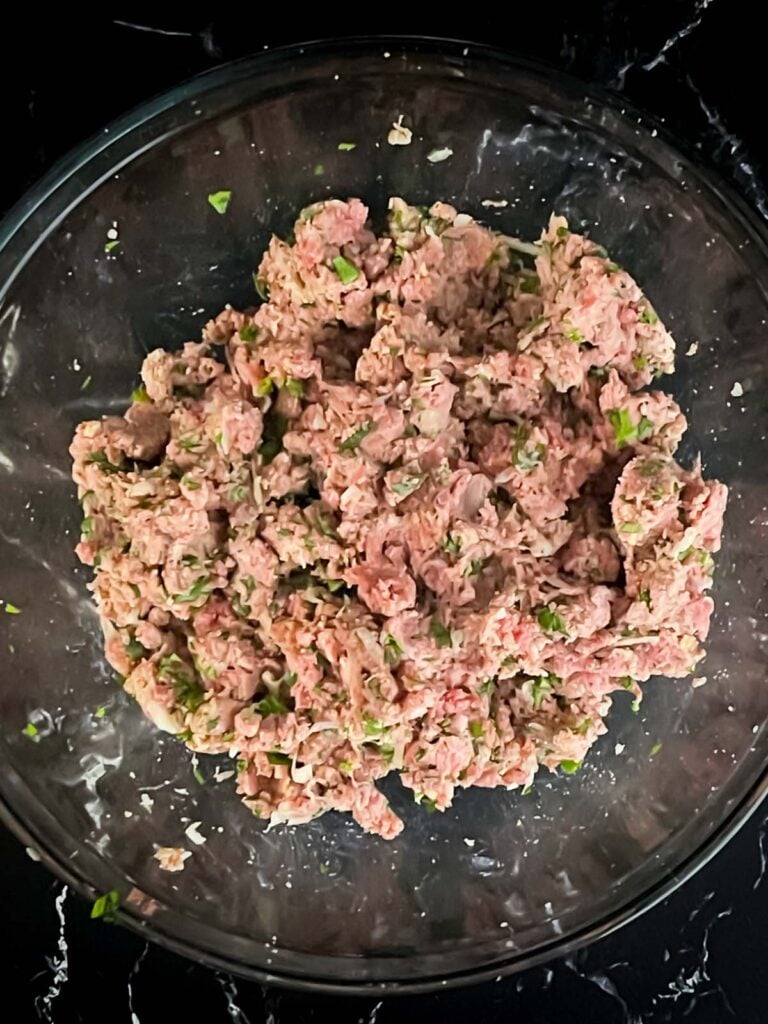 A ground beef mixture in a glass bowl.