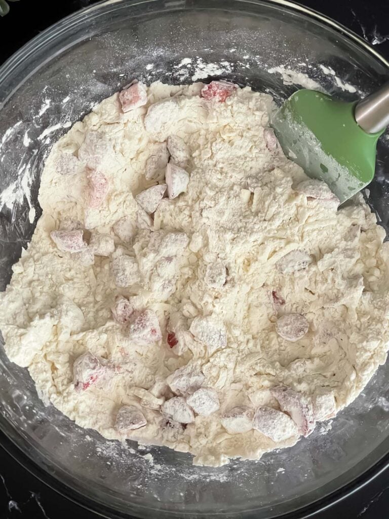 Strawberries mixed with dry ingredients for scones.
