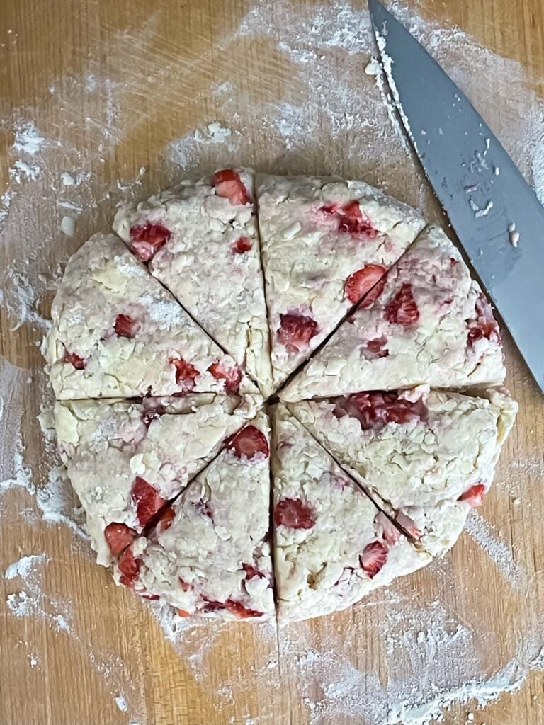 Strawberry scone dough round cut into 8 pieces.