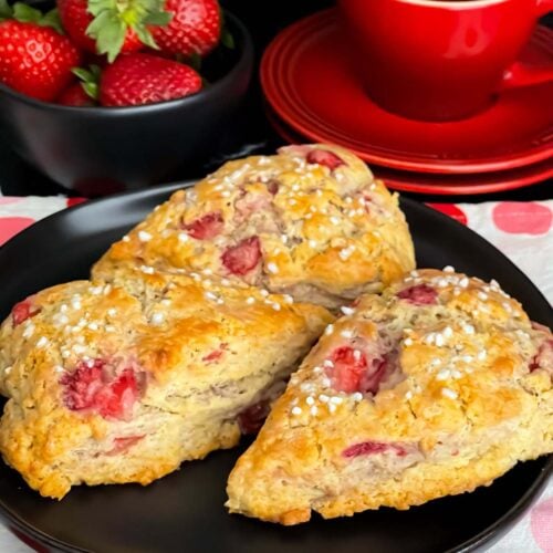 Strawberry scones on a dark plate.