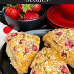 Strawberry scones on a dark plate.
