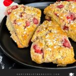 Strawberry scones on a dark plate.