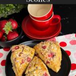 Strawberry scones on a dark plate.