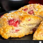 Strawberry scones on a dark plate.