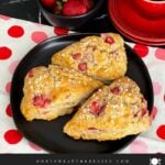 Strawberry scones on a dark plate.