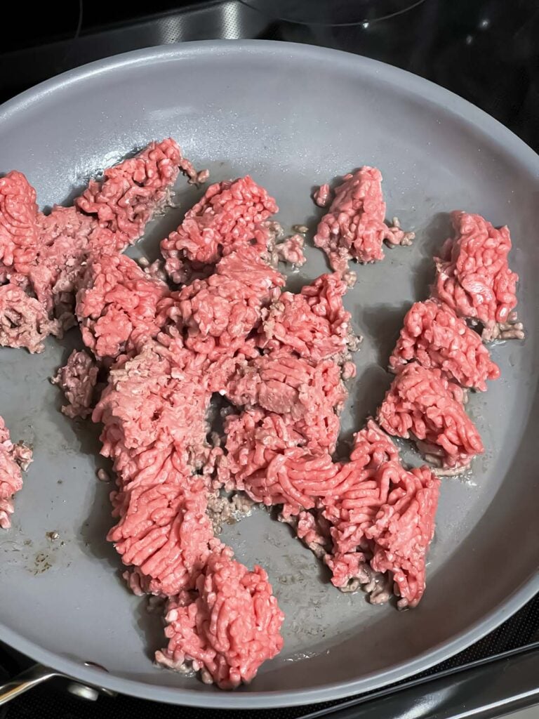 Browning ground beef in a skillet.