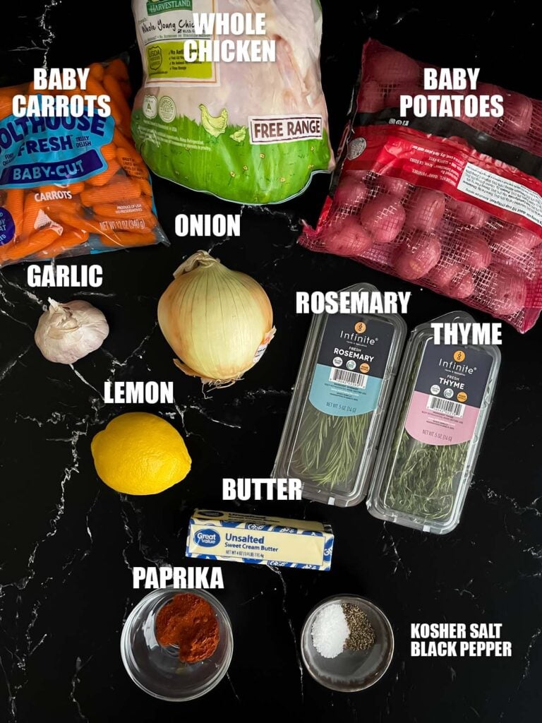 Slow cooker lemon herb whole chicken recipe ingredients on a dark surface.