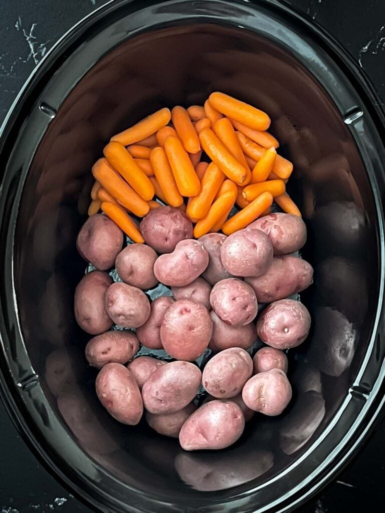 Carrots and potatoes in a crock pot.