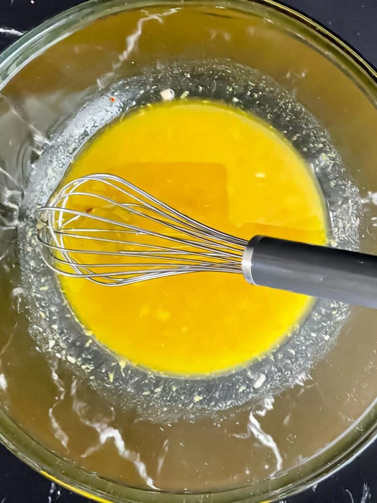 A simple lemon dressing in a glass bowl.