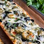 Olive cheese bread on a parchment paper lined baking sheet.