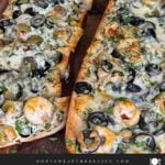Olive cheese bread on a wooden cutting board.