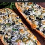Olive cheese bread on a wooden cutting board.