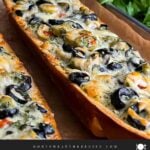 Olive cheese bread on a wooden cutting board.