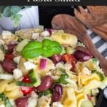 Tortellini pasta salad in a dark bowl.