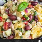 Tortellini pasta salad in a dark bowl.