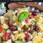 Tortellini pasta salad in a dark bowl.