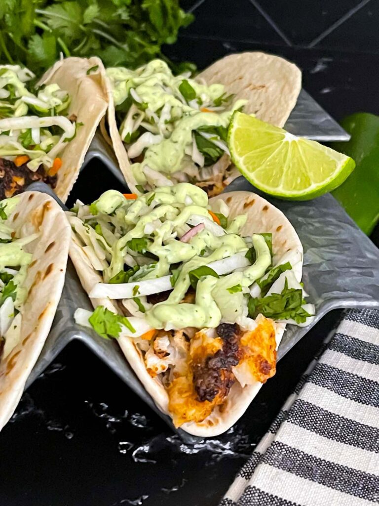 Blackened Fish Tacos on a dark background.