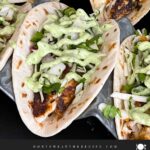 Blackened Fish Tacos on a dark background.