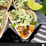 Blackened Fish Tacos on a dark background.