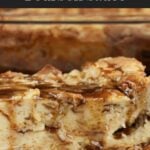 Bread pudding on a dark plate with a bourbon sauce drizzled over it.