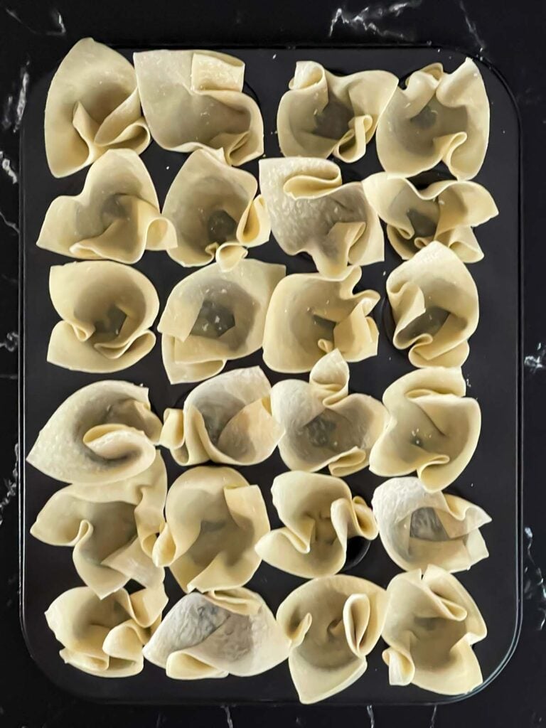 Wontons in a mini muffin pan.