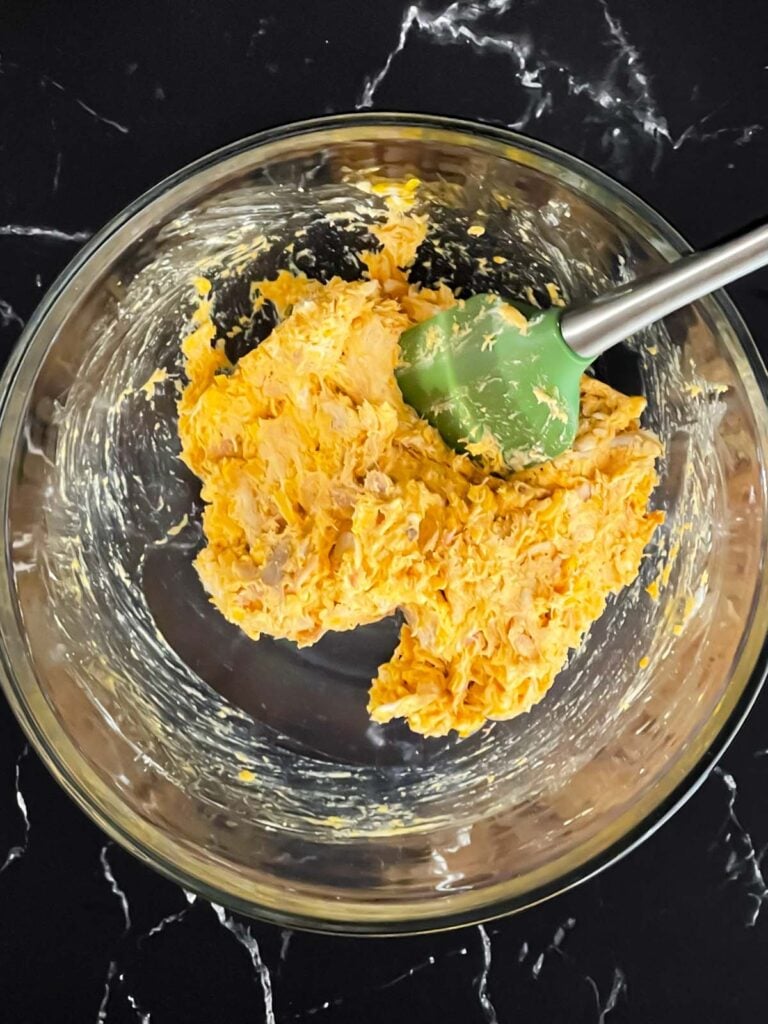 Buffalo chicken mixture combined in a mixing bowl.