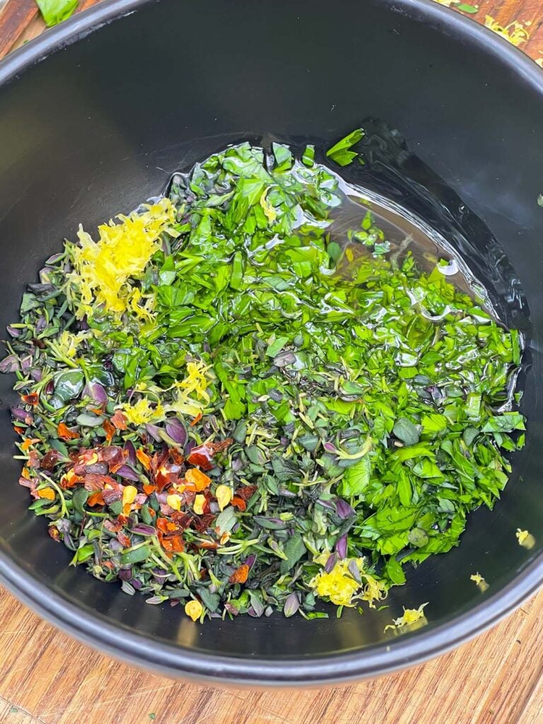 Chimichurri in a dark bowl.
