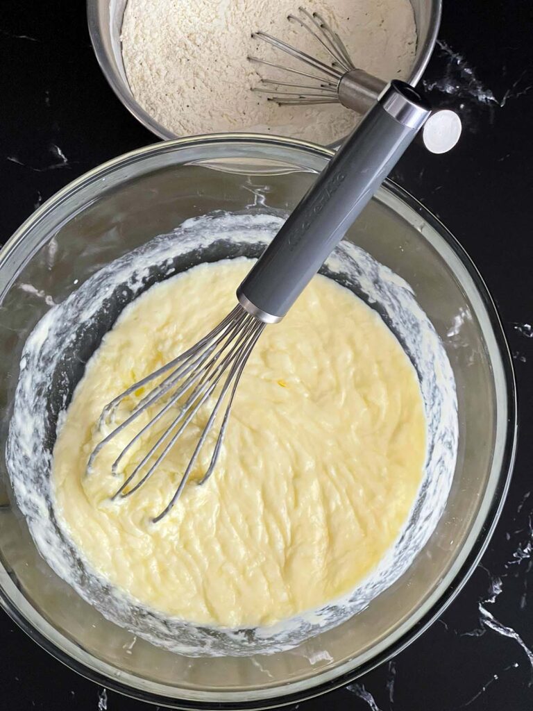 Eggs whisked into the wet ingredients for the herb and cheese muffins recipe.