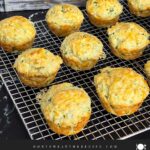 Herb and cheese muffins on a wire rack.