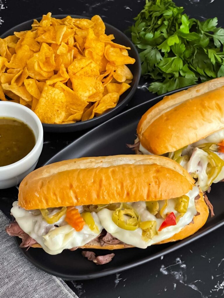 Italian beef sandwiches on a dark plate.