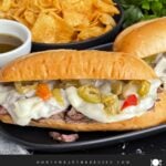 Italian beef sandwiches on a dark plate.