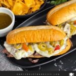 Italian beef sandwiches on a dark plate.