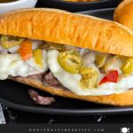 Italian beef sandwiches on a dark plate.