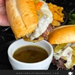Italian beef sandwich over a ramekin of au jus.