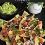 Pulled pork nachos with red onion, tomato, and jalapeno.