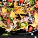 Pulled pork nachos with red onion, tomato, and jalapeno.
