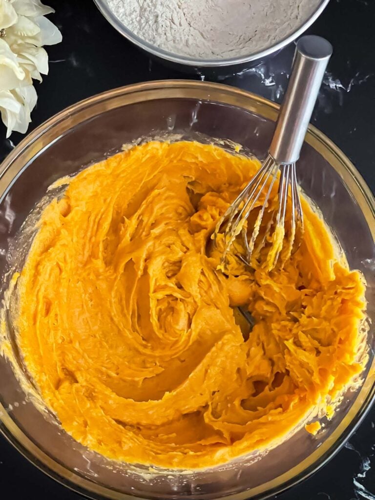 Pumpkin snickerdoodle wet ingredients combined in a glass bowl.