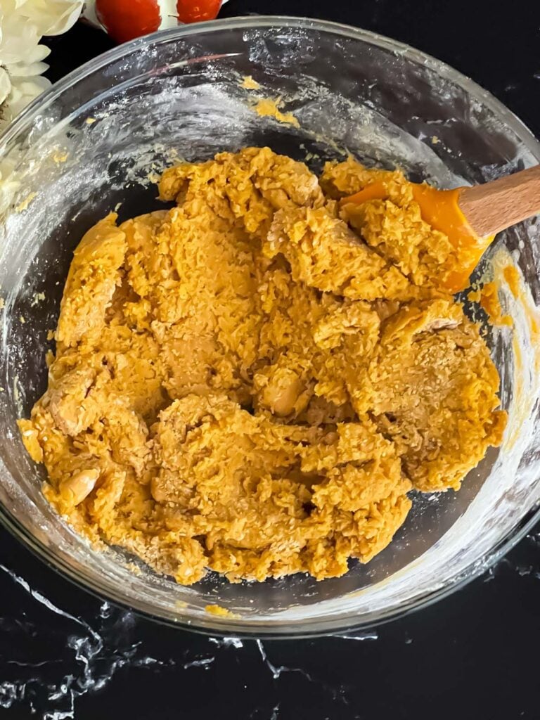 Pumpkin Snickerdoodles dough mixed in a glass bowl.