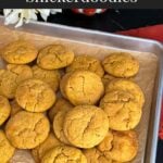 Pumpkin Snickerdoodle cookies on a parchment paper lined baking sheet.