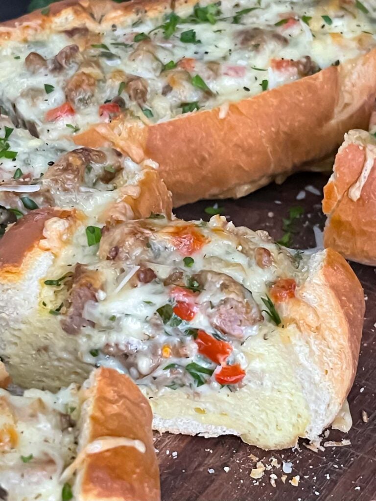 Sausage and Egg Baguette Bake cut up on a cutting board.