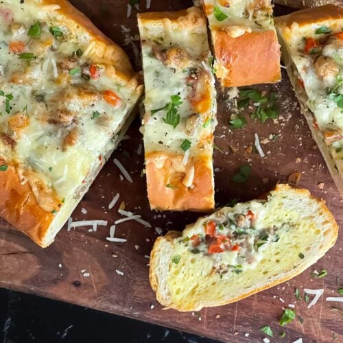 Sausage and Egg Baguette Bake cut up on a cutting board.