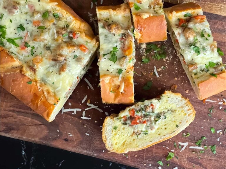 Sausage and Egg Baguette Bake cut up on a cutting board.