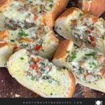 Sausage and Egg Baguette Bake cut up on a cutting board.