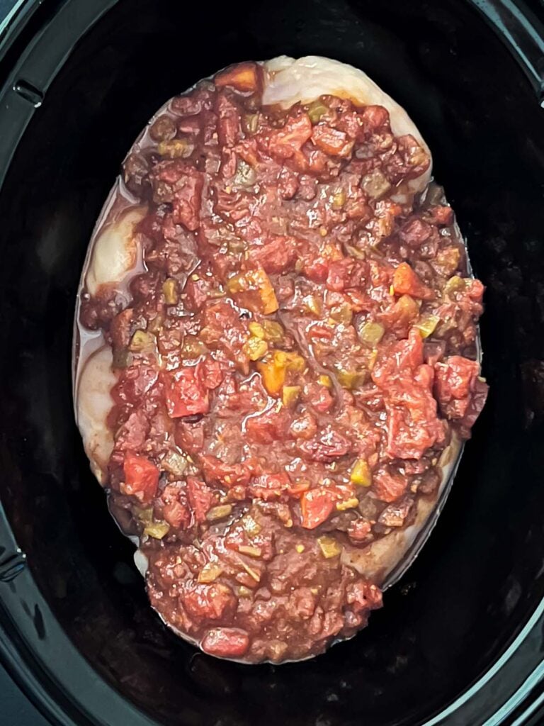 Mexican chicken seasoning mixture added over the chicken breasts in the slow cooker.