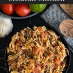 Slow cooker Mexican chicken in a dark bowl on a dark surface.