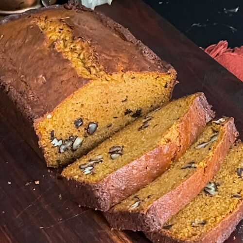 Sweet potato bread sliced on a wooden board.