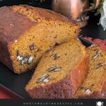 Sweet potato bread sliced on a dark platter.