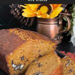 Sweet potato bread sliced on a dark platter.