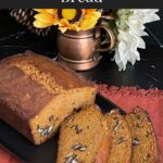 Sweet potato bread sliced on a dark platter.